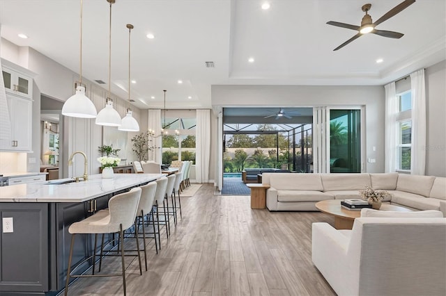 8209 Redonda Loop, Lakewood Ranch, FL 34202 - living room featuring a ceiling fan, plenty of natural light, recessed lighting, and light wood finished floors