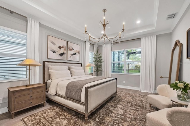 8209 Redonda Loop, Lakewood Ranch, FL 34202 - bedroom with a chandelier, light wood-style floors, a raised ceiling, and recessed lighting