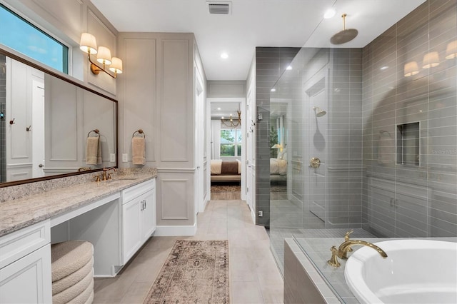 8209 Redonda Loop, Lakewood Ranch, FL 34202 - full bathroom with vanity, a bath, a shower stall, tile patterned flooring, and ensuite bath