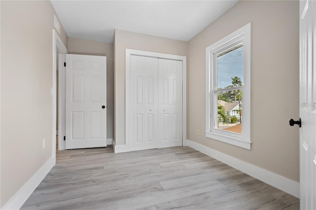 719 22nd St W, Bradenton, FL 34205 - unfurnished bedroom featuring light wood-type flooring and a closet