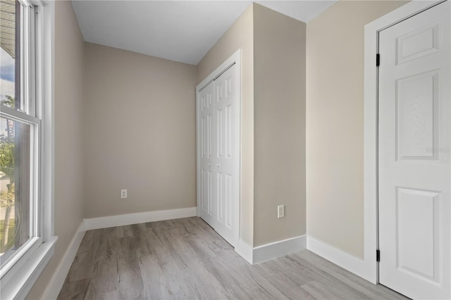 719 22nd St W, Bradenton, FL 34205 - unfurnished bedroom featuring light wood finished floors and a closet
