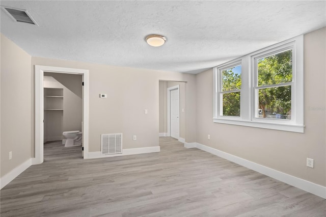 719 22nd St W, Bradenton, FL 34205 - spare room featuring light wood-style floors and a textured ceiling