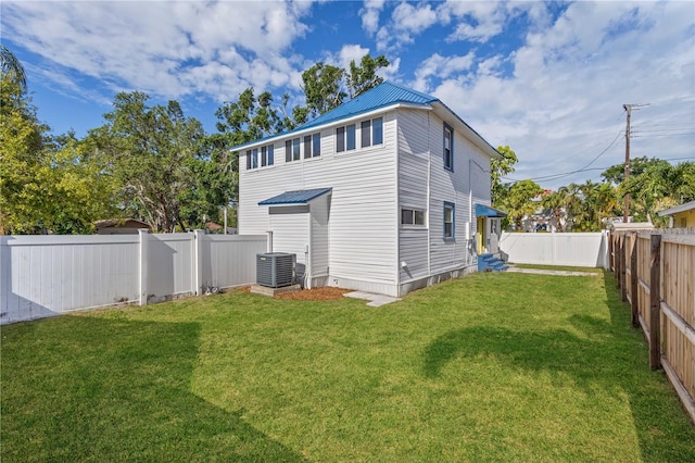 719 22nd St W, Bradenton, FL 34205 - back of house featuring entry steps, a metal roof, and a fenced backyard