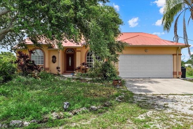 6805 225th St E, Bradenton, FL 34211 - view of front facade featuring stucco siding, concrete driveway, an attached garage, and a metal roof