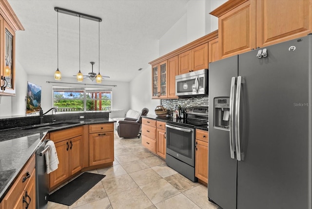 6805 225th St E, Bradenton, FL 34211 - kitchen with stainless steel appliances, tasteful backsplash, glass insert cabinets, light tile patterned floors, and pendant lighting
