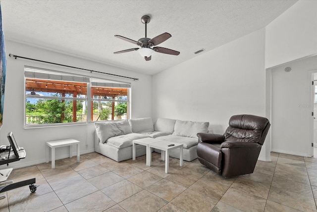 6805 225th St E, Bradenton, FL 34211 - living room with ceiling fan, a textured ceiling, lofted ceiling, and light tile patterned flooring