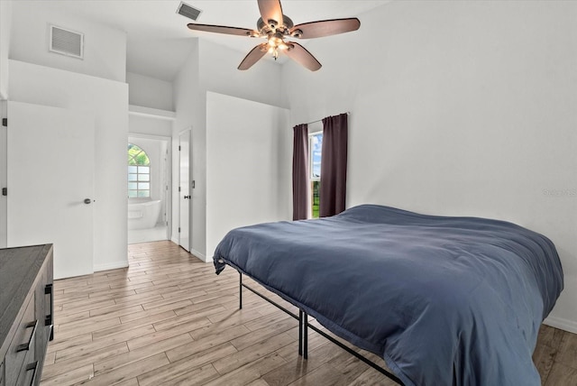 6805 225th St E, Bradenton, FL 34211 - bedroom with high vaulted ceiling, light wood-type flooring, a ceiling fan, and ensuite bathroom