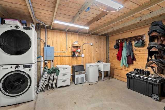 6805 225th St E, Bradenton, FL 34211 - laundry area with stacked washing machine and dryer, electric panel, and wooden walls