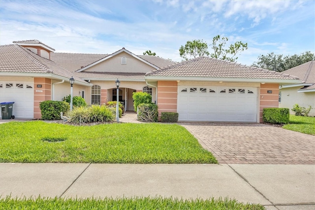 2025 Lynx Run, North Port, FL 34288 - ranch-style house featuring a garage, driveway, stucco siding, a front lawn, and a tiled roof