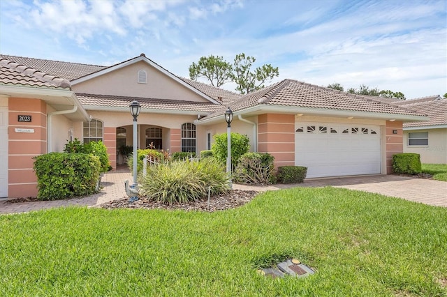 2025 Lynx Run, North Port, FL 34288 - view of front of property featuring stucco siding, a garage, and a front lawn