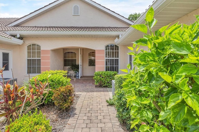 2025 Lynx Run, North Port, FL 34288 - view of exterior entry featuring stucco siding and a tile roof
