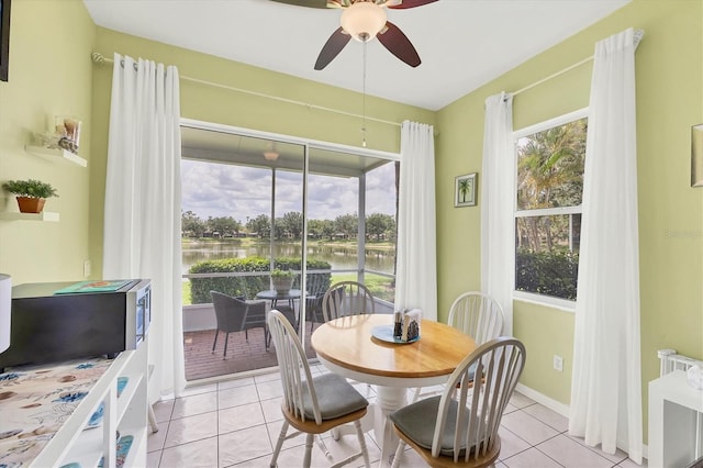 2025 Lynx Run, North Port, FL 34288 - dining area with radiator heating unit, ceiling fan, a water view, and light tile patterned floors