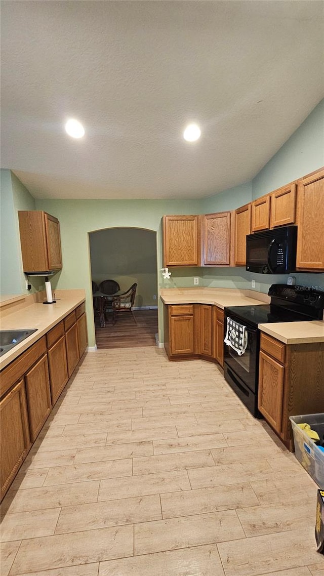 17215 Berwin Ave, Port Charlotte, FL 33948 - kitchen with black appliances, light wood-style floors, light countertops, and recessed lighting