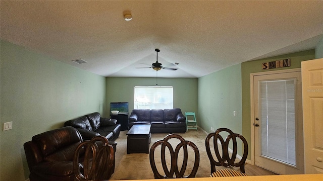 17215 Berwin Ave, Port Charlotte, FL 33948 - living area featuring a ceiling fan, carpet, lofted ceiling, and a textured ceiling