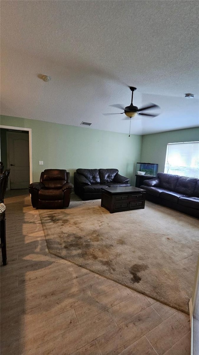 17215 Berwin Ave, Port Charlotte, FL 33948 - living area featuring wood finished floors, a textured ceiling, and ceiling fan