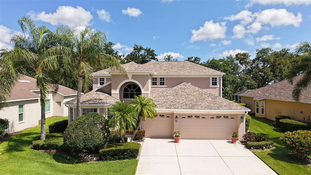 7915 Kavanagh Ct, Sarasota, FL 34240 - view of front of home with stucco siding, driveway, a garage, and a front lawn