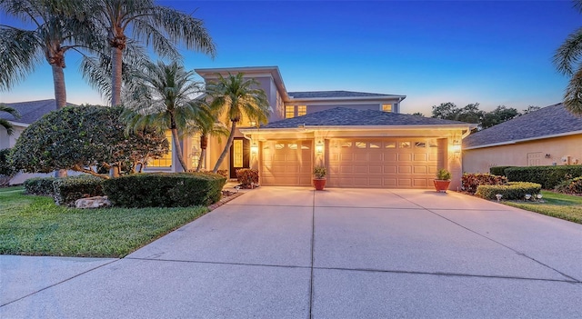 7915 Kavanagh Ct, Sarasota, FL 34240 - view of front facade featuring a garage, driveway, stucco siding, and a front yard