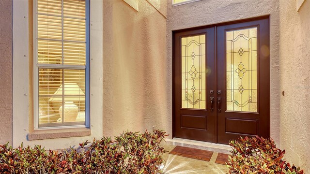 7915 Kavanagh Ct, Sarasota, FL 34240 - entrance to property with french doors and stucco siding