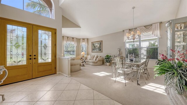 7915 Kavanagh Ct, Sarasota, FL 34240 - carpeted foyer featuring french doors, a chandelier, and tile patterned flooring