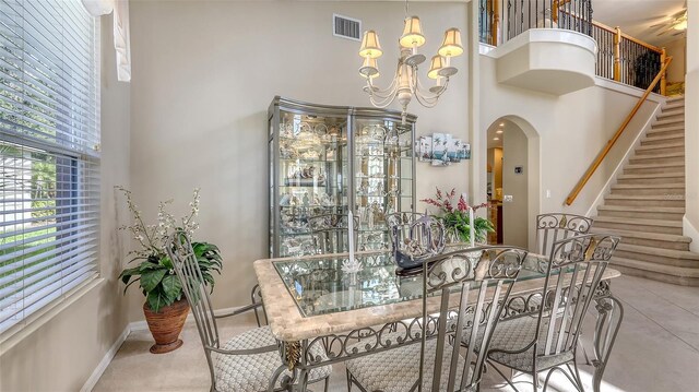 7915 Kavanagh Ct, Sarasota, FL 34240 - dining room with a towering ceiling, arched walkways, stairs, and a chandelier