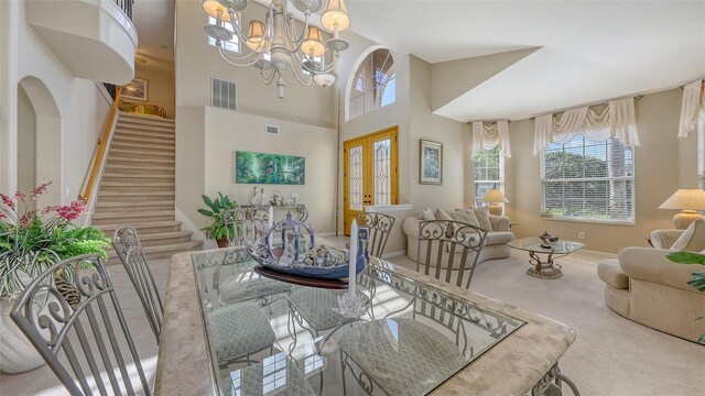 7915 Kavanagh Ct, Sarasota, FL 34240 - carpeted dining area featuring stairs, a chandelier, and a high ceiling