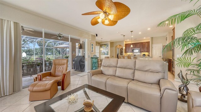 7915 Kavanagh Ct, Sarasota, FL 34240 - living room featuring a ceiling fan, light tile patterned flooring, recessed lighting, crown molding, and a sunroom