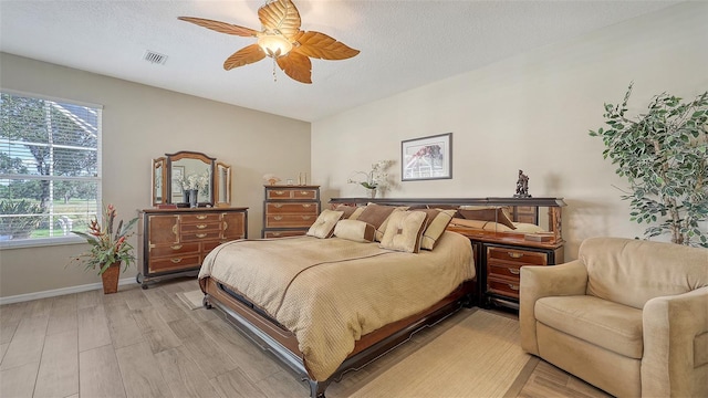7915 Kavanagh Ct, Sarasota, FL 34240 - bedroom with light wood-style flooring and ceiling fan