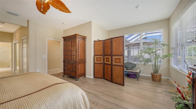 7915 Kavanagh Ct, Sarasota, FL 34240 - bedroom featuring light wood-type flooring and ceiling fan