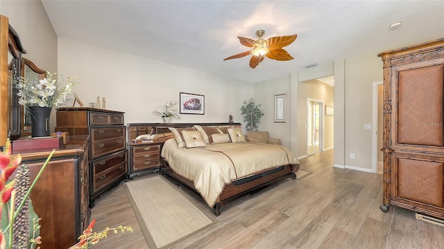 7915 Kavanagh Ct, Sarasota, FL 34240 - bedroom with light wood finished floors and ceiling fan