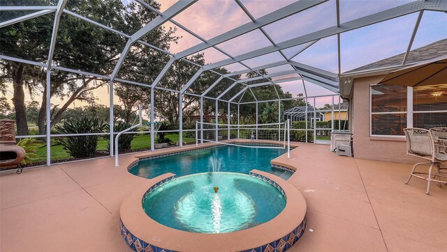 7915 Kavanagh Ct, Sarasota, FL 34240 - pool at dusk with a pool with connected hot tub, a patio, and glass enclosure