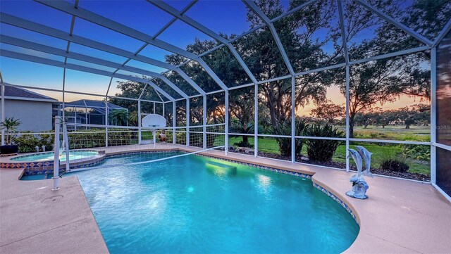 7915 Kavanagh Ct, Sarasota, FL 34240 - pool at dusk with a pool with connected hot tub, a patio, and glass enclosure