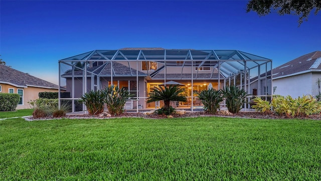 7915 Kavanagh Ct, Sarasota, FL 34240 - rear view of property featuring a yard and glass enclosure
