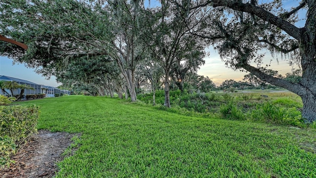 7915 Kavanagh Ct, Sarasota, FL 34240 - yard at dusk with a lawn