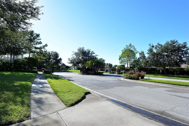 6214 45th Ln E, Bradenton, FL 34203 - view of asphalt road featuring curbs and sidewalks