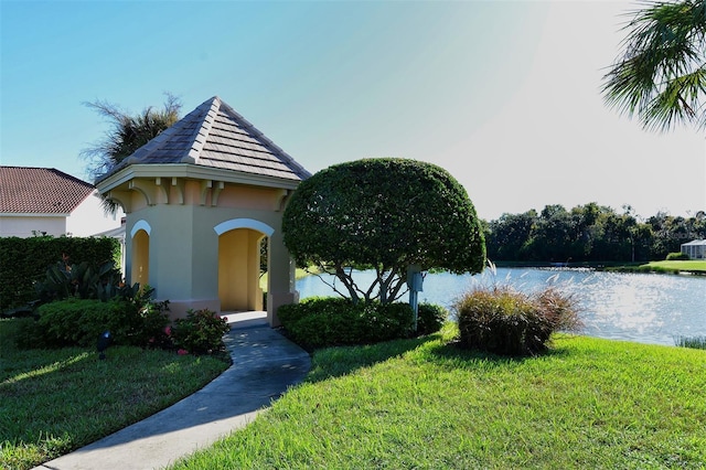6214 45th Ln E, Bradenton, FL 34203 - view of front of home with stucco siding, a front yard, a water view, and a tiled roof