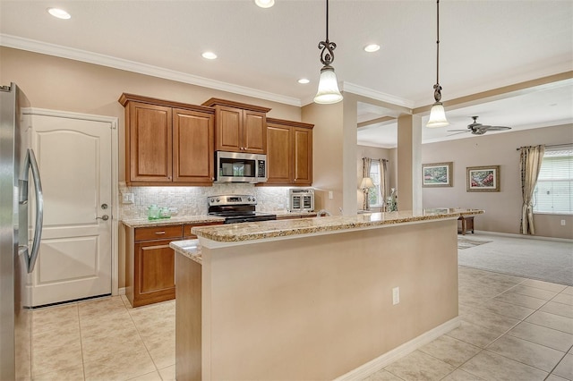 6214 45th Ln E, Bradenton, FL 34203 - kitchen with appliances with stainless steel finishes, brown cabinets, light stone counters, crown molding, and light colored carpet