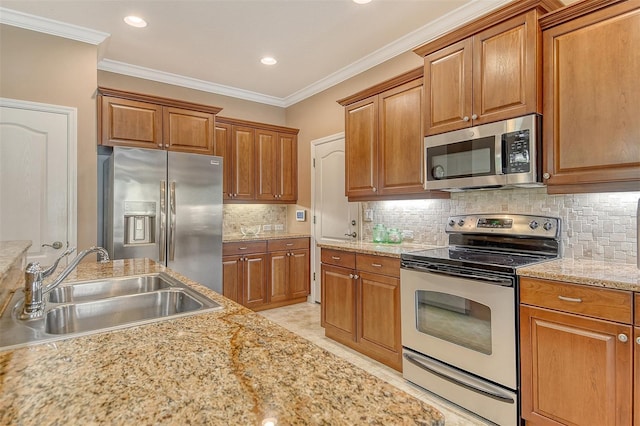 6214 45th Ln E, Bradenton, FL 34203 - kitchen with stainless steel appliances, brown cabinets, crown molding, recessed lighting, and backsplash