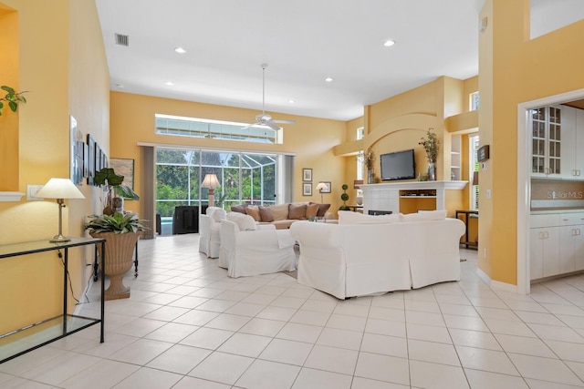 4374 Mirabella Cir, Bradenton, FL 34210 - living room featuring a ceiling fan, a towering ceiling, light tile patterned flooring, and recessed lighting