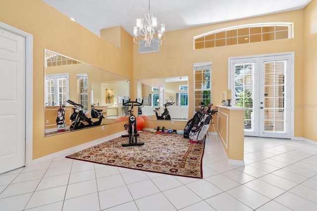 4374 Mirabella Cir, Bradenton, FL 34210 - workout area featuring a chandelier, light tile patterned floors, and a towering ceiling