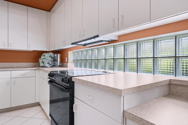 4374 Mirabella Cir, Bradenton, FL 34210 - kitchen with electric range, light countertops, white cabinetry, and light tile patterned flooring