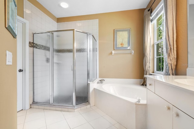 4374 Mirabella Cir, Bradenton, FL 34210 - bathroom featuring a stall shower, a garden tub, vanity, and tile patterned flooring