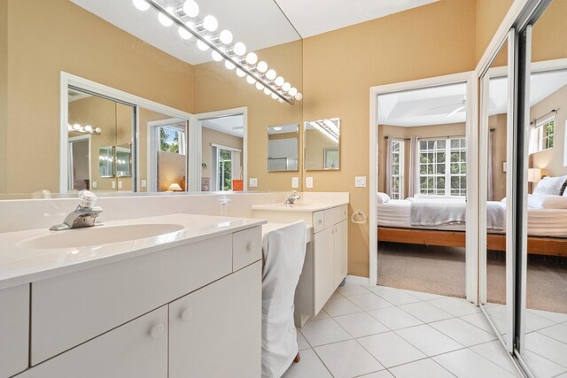 4374 Mirabella Cir, Bradenton, FL 34210 - bathroom with connected bathroom, vanity, and tile patterned flooring