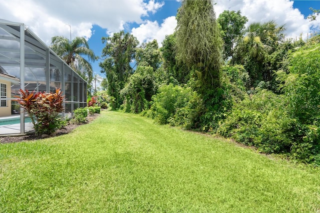 4374 Mirabella Cir, Bradenton, FL 34210 - view of green lawn featuring an outdoor pool and a lanai
