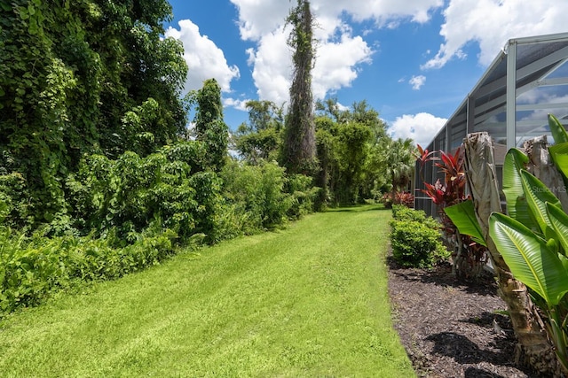 4374 Mirabella Cir, Bradenton, FL 34210 - view of grassy yard featuring glass enclosure