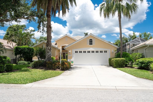 4374 Mirabella Cir, Bradenton, FL 34210 - view of front of house with a garage, stucco siding, driveway, and a front lawn