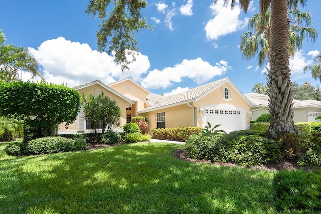 4374 Mirabella Cir, Bradenton, FL 34210 - view of front of property featuring stucco siding, a garage, and a front yard