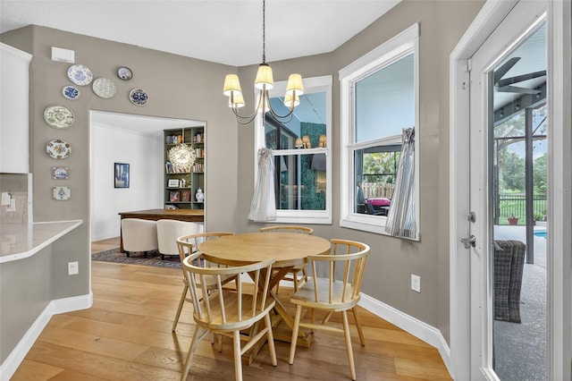 13640 2nd Ave E, Bradenton, FL 34212 - dining space with light wood-style flooring and a chandelier