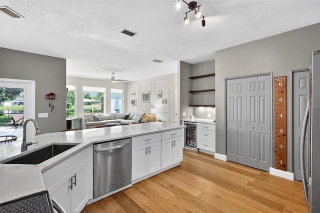 13640 2nd Ave E, Bradenton, FL 34212 - kitchen with stainless steel appliances, wine cooler, a textured ceiling, ceiling fan, and light wood-type flooring