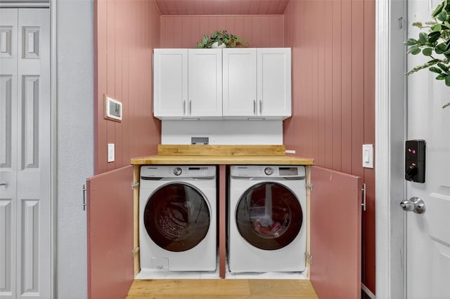13640 2nd Ave E, Bradenton, FL 34212 - laundry area featuring washer and dryer, cabinet space, and wooden walls