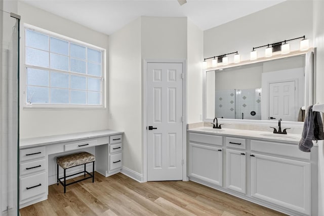 13640 2nd Ave E, Bradenton, FL 34212 - full bathroom with double vanity, a stall shower, and wood finished floors